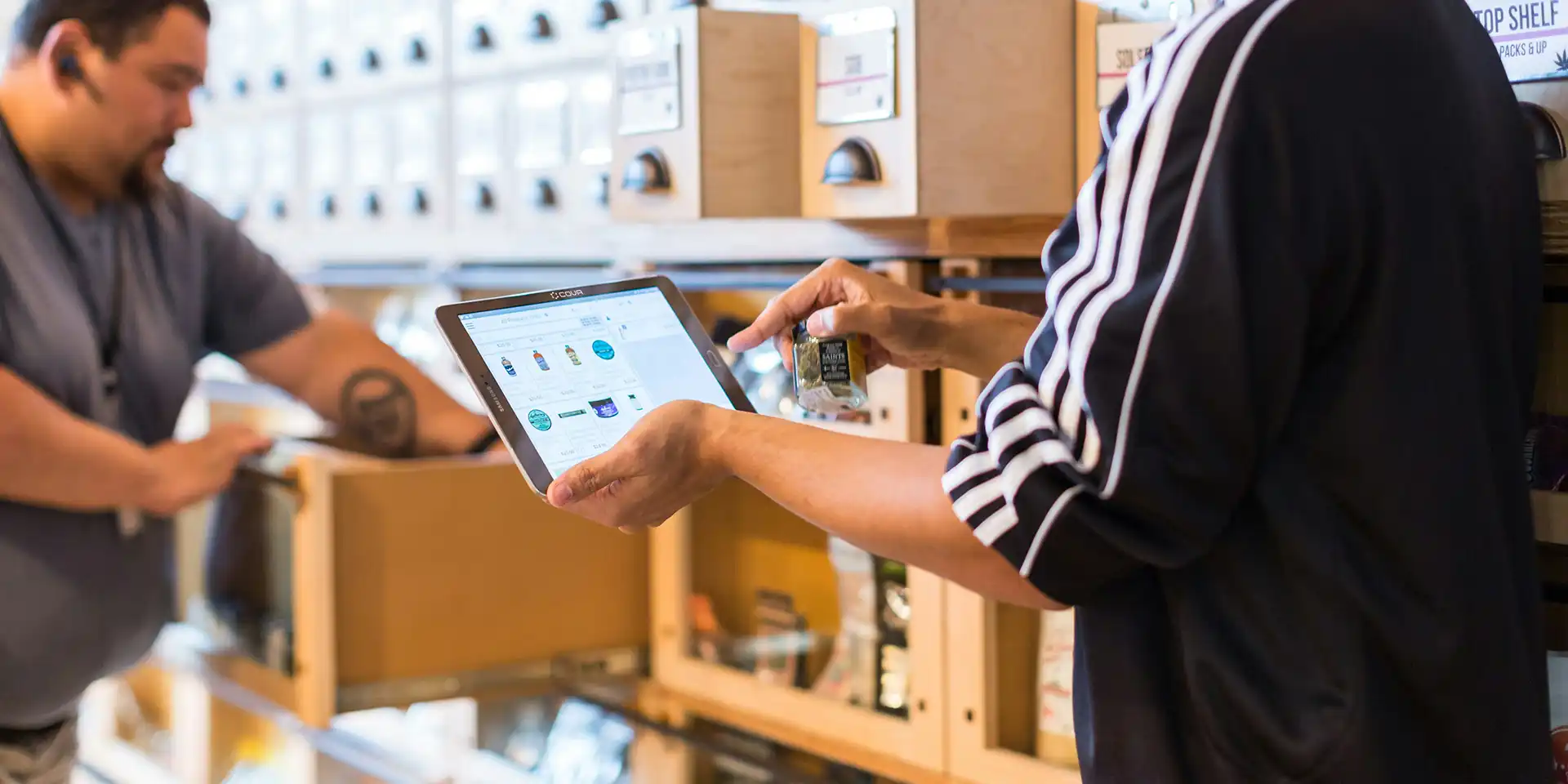 Uncle Ike's Careers - Employee helping customer with tablet